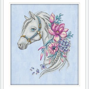 May include: A framed cross-stitch art piece featuring a white horse head adorned with pink, purple, and blue flowers. The horse has a blue bridle and is set against a light blue background.