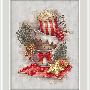 May include: A cross-stitch design featuring a stack of three mugs, decorated with a red and white striped pattern, a red bow, and a snowflake cookie. The mugs are adorned with whipped cream, pine needles, and berries, creating a festive holiday theme.