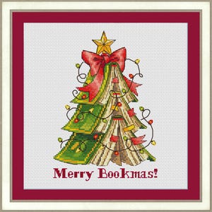 May include: Cross-stitch image of a Christmas tree formed from books, decorated with a red bow, star, and fairy lights. The design is set against a white backdrop, framed by a red border, with the text "Merry Bookmas!" at the base.