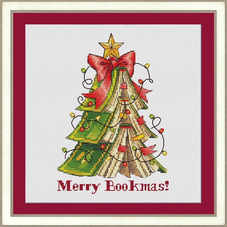 May include: Cross-stitch design of a Christmas tree made of books, adorned with a red bow, star, and string lights. The tree is set against a white background, framed by a red border, and the text "Merry Bookmas!" appears at the bottom.