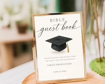 May include: A rectangular sign in a gold frame featuring the text BIBLE guest book, a black graduation cap with a gold tassel, and the text PLEASE HIGHLIGHT YOUR FAVORITE VERSE AND LEAVE A NOTE FOR THE GRADUATE, TARA'S GRADUATION, JUNE 12 202X.