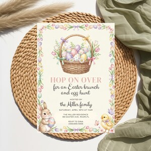 May include: Easter-themed invitation with a wicker basket filled with colorful eggs and flowers. The invitation reads "Hop on Over for an Easter brunch and egg hunt" and includes details about the event, including the host, date, time, and location.