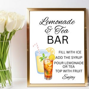 May include: A framed sign with the text Lemonade & Tea BAR, featuring illustrations of a glass of lemonade and a glass of iced tea with a straw, and instructions: FILL WITH ICE, ADD THE SYRUP, POUR LEMONADE OR TEA, TOP WITH FRUIT, Enjoy.