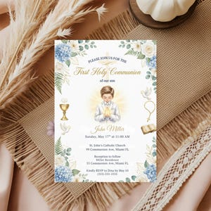 May include: A First Holy Communion invitation featuring a watercolor illustration of a boy in a white suit holding a candle. The invitation includes text, floral accents, and details for the event, including the date, time, and location.
