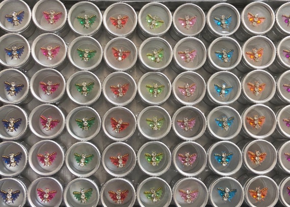 Metal tray of tiny butterflies self adhesive reusable each in a metal container 54 of them, amazing party favors assorted colors