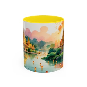 May include: A ceramic coffee mug with a yellow interior and a watercolor illustration of a river scene with temples, floating lanterns, and a colorful sunset. The mug is cylindrical and has a white exterior.
