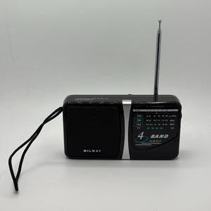 May include: Black portable radio with a silver antenna and a black carrying strap. The radio has a speaker, a tuning dial, and the text "4 BAND". The brand name "MILWAY" is visible on the front.
