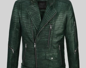 May include: A dark green, textured leather jacket with a crocodile pattern. The jacket features a classic biker style with multiple zippered pockets, a belted waist, and a notched collar. The jacket has a zipper closure and a snap-down lapel.