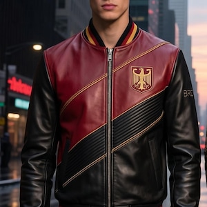 May include: A black and burgundy leather bomber jacket with a gold and black emblem on the chest. The jacket has a zipper closure and ribbed cuffs and hem with red, yellow, and black stripes. The jacket is worn with black leather pants.