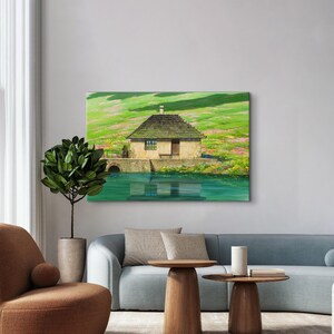 May include: A painting of a small, brown, wooden house with a thatched roof, sitting on a green grassy hill next to a body of water. The house has a single window and a door. The water reflects the house and the sky.