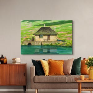 May include: A painting of a small, brown, wooden house with a thatched roof, sitting on a grassy hill next to a body of water. The house has a single window and a door. The water is a bright blue and reflects the sky and the house.