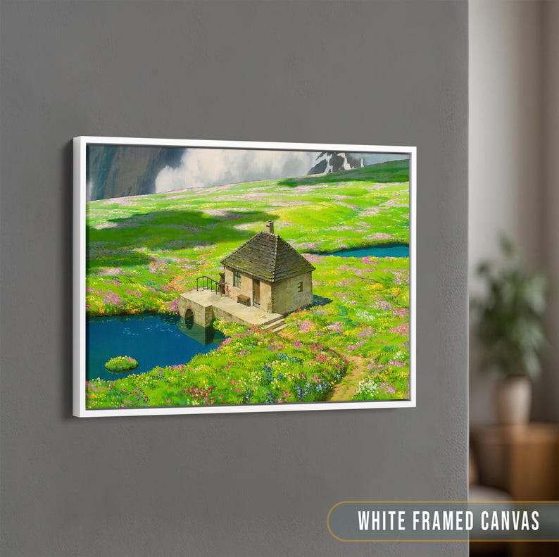 May include: A white framed canvas print of a small stone house with a green roof, surrounded by a field of wildflowers and a small pond. The house is nestled in a valley with mountains in the background.