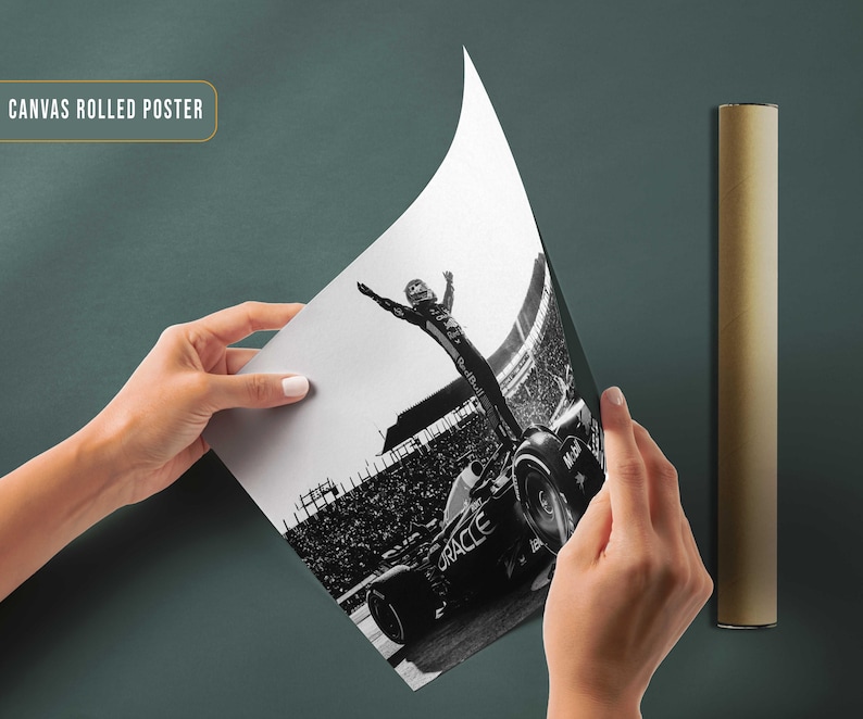 May include: A black and white canvas rolled poster featuring a Formula 1 race car and a driver celebrating a victory. The poster is being held up, revealing the image, with a rolled poster tube beside it. The text "CANVAS ROLLED POSTER" is visible.