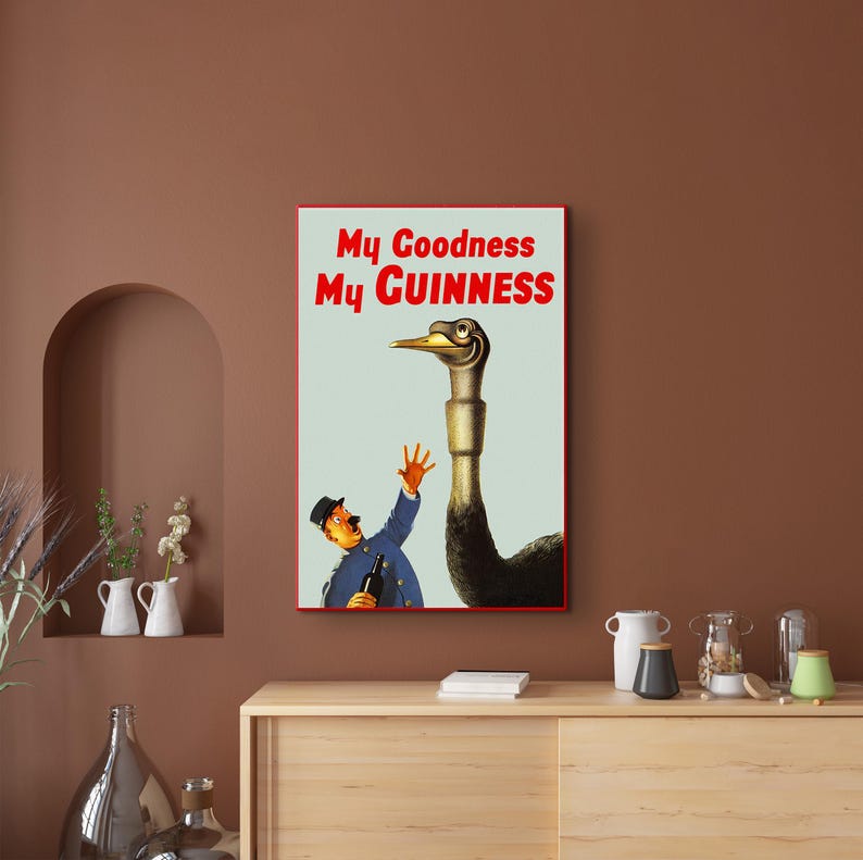 May include: A vintage advertisement for Guinness beer featuring a man in a blue uniform holding a bottle of Guinness and an ostrich with the text "My Goodness My GUINNESS".