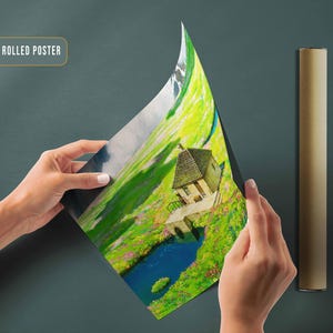 May include: A canvas rolled poster featuring a painting of a small house with a green roof, nestled in a lush green valley with a blue lake. The house has a white door and windows. The valley is surrounded by mountains in the background.