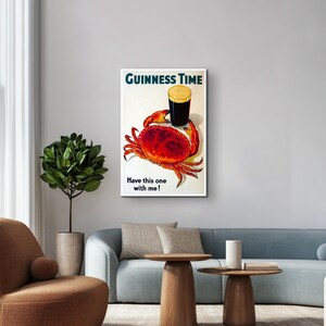 May include: A vintage Guinness beer advert featuring a red crab holding a glass of Guinness with the text "GUINNESS TIME" and "Have this one with me!"