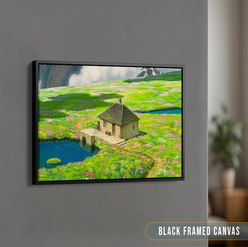 May include: A black framed canvas print of a painting depicting a small stone cottage in a green field with a blue lake in the foreground. The cottage has a brown roof and a white door. The field is covered in wildflowers.