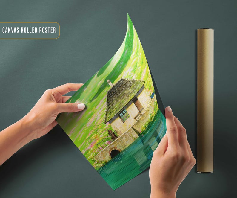 May include: A canvas rolled poster featuring a painting of a small house with a thatched roof, surrounded by green grass and water. The house is painted in a light brown color with white trim. The water is a deep blue color and the grass is a bright green. The poster is rolled up and being held by a person's hands.