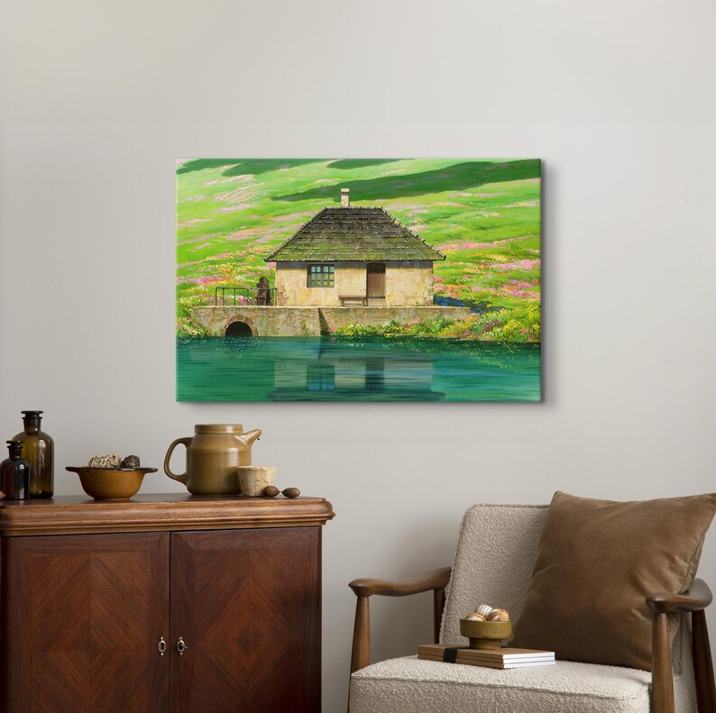 May include: A painting of a small, brown cottage with a green roof, sitting on a grassy hill next to a body of water. The cottage has a single window and a door. The water is a bright blue and reflects the sky.