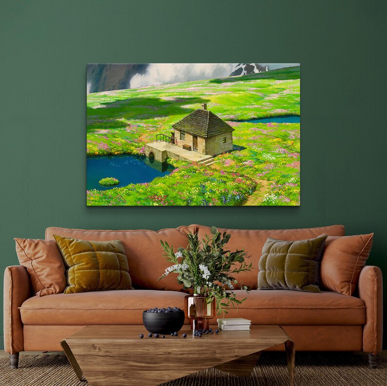 May include: A painting of a small, brown cottage with a green roof, nestled in a lush green meadow with wildflowers and two small ponds. The cottage has a white door and windows, and a small wooden bridge leads to it.