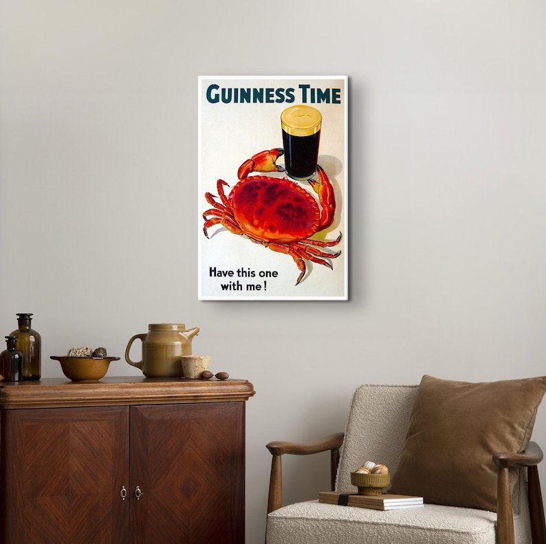 May include: A vintage Guinness beer advert featuring a glass of Guinness and a red crab with the text "GUINNESS TIME" and "Have this one with me!"