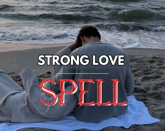 May include: Image of two people on a beach, one sitting and the other lying down. They are wearing gray sweaters and are on a white towel. The text "STRONG LOVE SPELL" is overlaid on the image in white and red.