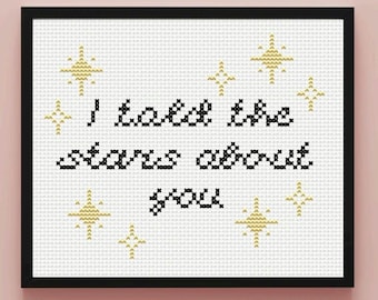 May include: A white cross-stitch embroidery with black text that reads "I tell the stars about you" and gold star accents.