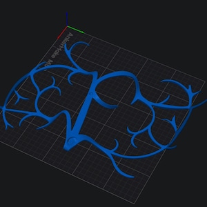 May include: A blue, stylized, 3D-rendered design resembling a network of veins or branches. The design is on a grid, with the text "AnkerMake M5" visible in the background. The overall shape is symmetrical and organic.