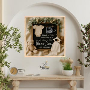 May include: A framed pregnancy announcement with a neutral color scheme. The announcement includes a letter board with the text "COULD BE PINK, COULD BE BLUE, ALL WE KNOW IS THAT We're Due DECEMBER 2026." A teddy bear, baby clothes, and a sonogram image are also featured.