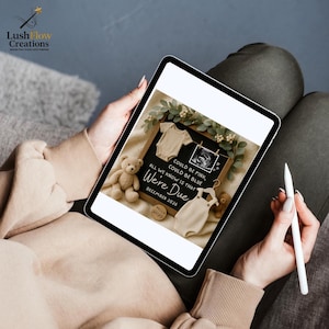 May include: A digital tablet displays a pregnancy announcement. The announcement features a black chalkboard with the text "Could be Pink, Could be Blue, All We Know Is That We're Due December 2026." The image includes baby clothes and a teddy bear.