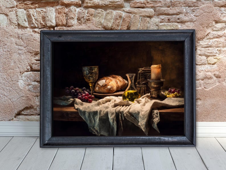 May include: A framed still life painting featuring a loaf of bread, grapes, a glass of wine, and a bottle of olive oil. A lit candle and a draped cloth complete the scene. The painting is set against a brick wall and a wooden floor.