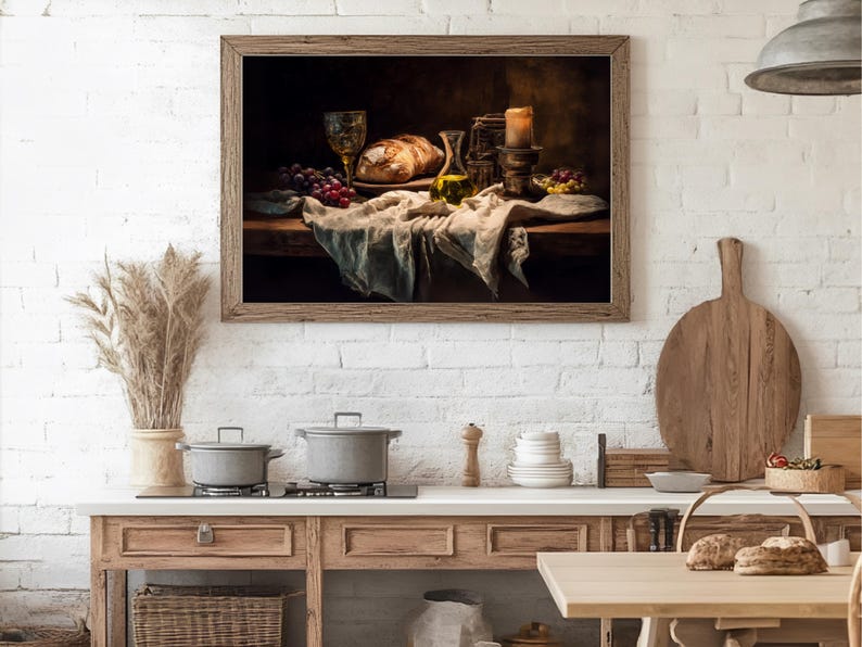 May include: A framed still life painting depicts a rustic table setting. A loaf of bread, grapes, and a glass of wine are arranged on a draped cloth. A lit candle and olive oil bottle add to the ambiance. The painting is set against a white brick wall.