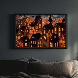 May include: A framed watercolor painting depicts a nighttime cityscape with illuminated houses and trees in autumn colors. The artwork features a dark sky with bats and a full moon, creating a spooky, Halloween-themed scene.