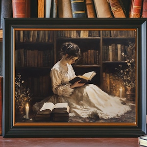 May include: A framed painting depicting a woman in a white dress reading a book in a library setting. The woman is seated on the floor with a book in her lap and a candle lit on the floor beside her. The library shelves are filled with books and there is a soft glow of light emanating from the candle.