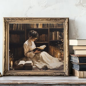 May include: A framed painting depicting a woman reading a book in a library setting. The woman is wearing a white dress and is seated in a chair. The library is filled with bookshelves and there are candles on the table.