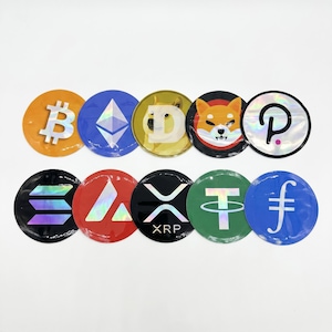 May include: A collection of ten round stickers featuring cryptocurrency logos. The stickers include Bitcoin, Ethereum, Dogecoin, Shiba Inu, Polkadot, Solana, Avalanche, XRP, Tether, and Filecoin. Each sticker has a unique color and design.