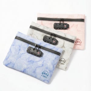 May include: Three rectangular pouches with marble patterns in light blue, gray, and pink. Each pouch features a black zipper closure with a built-in black combination lock and a circular logo with the letters SZ and the text STASHERZ.