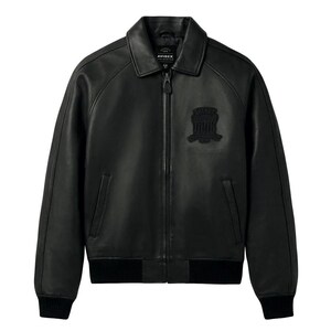 Front view of a handmade men's black lambskin leather bomber jacket with a metallic front zipper, classic side pockets, and ribbed cuffs.