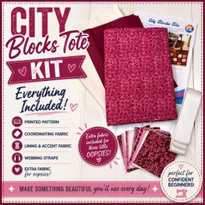 May include: A City Blocks Tote Kit containing fabric pieces in shades of pink, maroon, and cream, a roll of white webbing straps, and a printed instruction sheet. The kit includes coordinating fabric, lining, accent fabric, and extra fabric pieces.