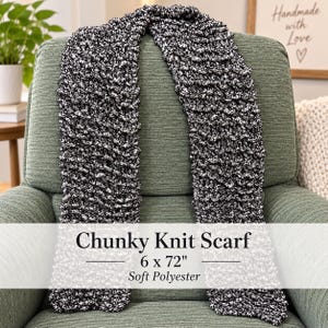May include: A chunky knit scarf made of soft polyester, featuring a black and white speckled pattern. The scarf measures 6 by 72 inches. Text overlay on the image reads: Chunky Knit Scarf, 6 x 72", Soft Polyester.