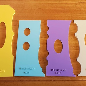 May include: Set of six colorful plastic stencils with different shapes and sizes. The stencils are designed for crafting and decorating projects.