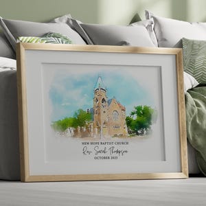 May include: A framed watercolor print of New Hope Baptist Church. The artwork features a church with a tall steeple, set against a blue sky and green trees. The text reads "New Hope Baptist Church, Rev. Sarah Thompson, October 2025."
