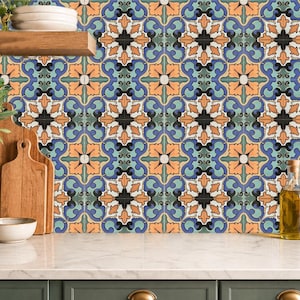 May include: A kitchen scene featuring a colorful tile backsplash with a repeating floral pattern in blue, orange, and green. Wooden cutting boards, a white bowl, and a plant in a pot are on the countertop.