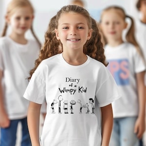 May include: A white t-shirt with the text "Diary of a Wimpy Kid" and cartoon illustrations of characters. Several children are wearing white t-shirts in the background.