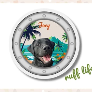May include: A circular wall plaque designed like a ship porthole with a silver frame featuring rivets. Inside, a graphic shows a black Labrador dog, palm trees, and the ocean. The name Joey is printed in orange, and the text ruff life is in green.