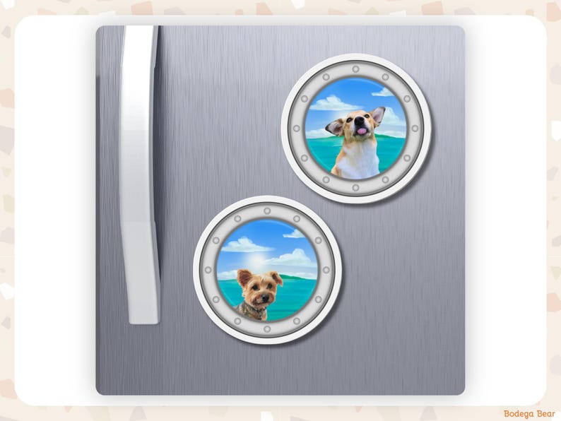 A grey fridge featuring two custom photo porthole magnets of small dogs against a seascape background.