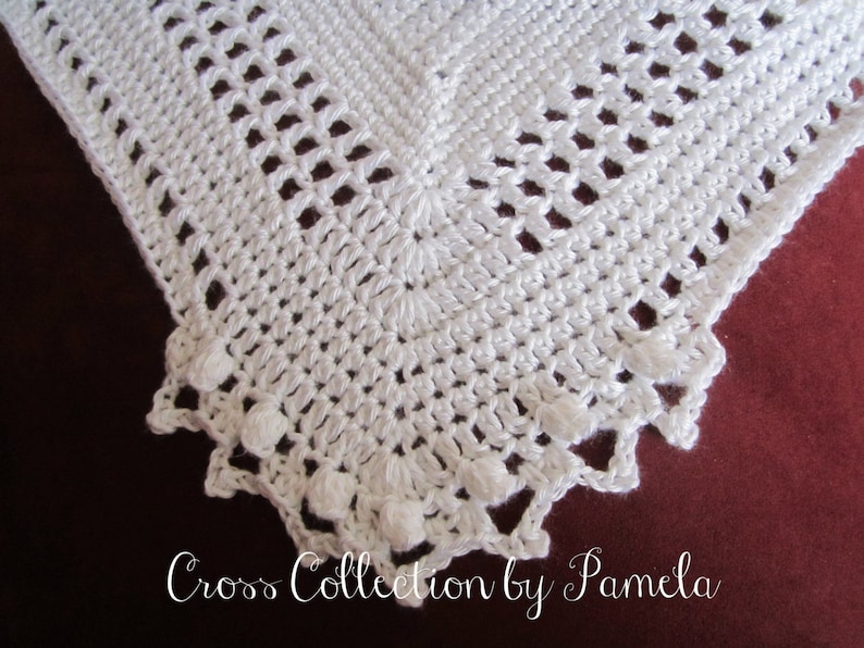 A crochet baby blanket pattern featuring a center cross design accented with a beautiful border. Easy crochet stitches. Pattern has been professionally edited. Finished size is about 24 by 30 inches. Perfect to crochet for your newborn or as a gift.