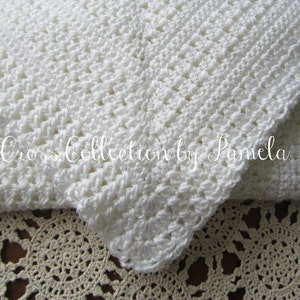 A crochet baby blanket pattern featuring a center cross design accented with a beautiful border. Easy crochet stitches. Pattern has been professionally edited. Finished size is about 28 by 32 inches. Perfect to crochet for a newborn or as a gift.