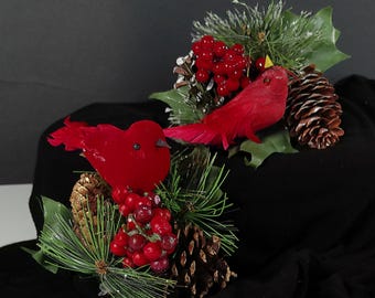 Vintage Cardinal Clip on ornaments sitting on faux evergreen branches, pinecones and red berries