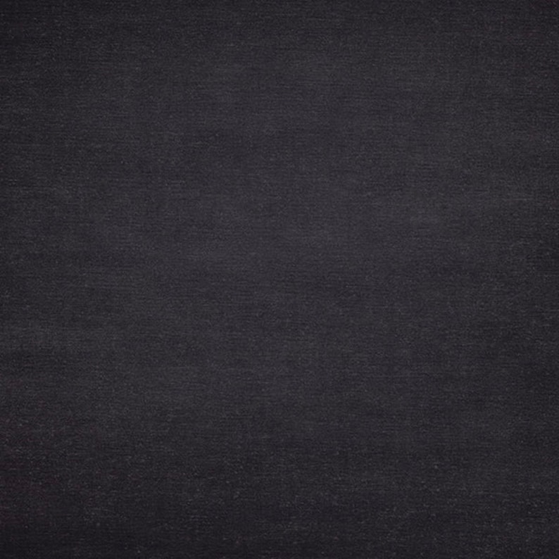 May include: A dark grey textured background with a subtle, fine grain pattern.